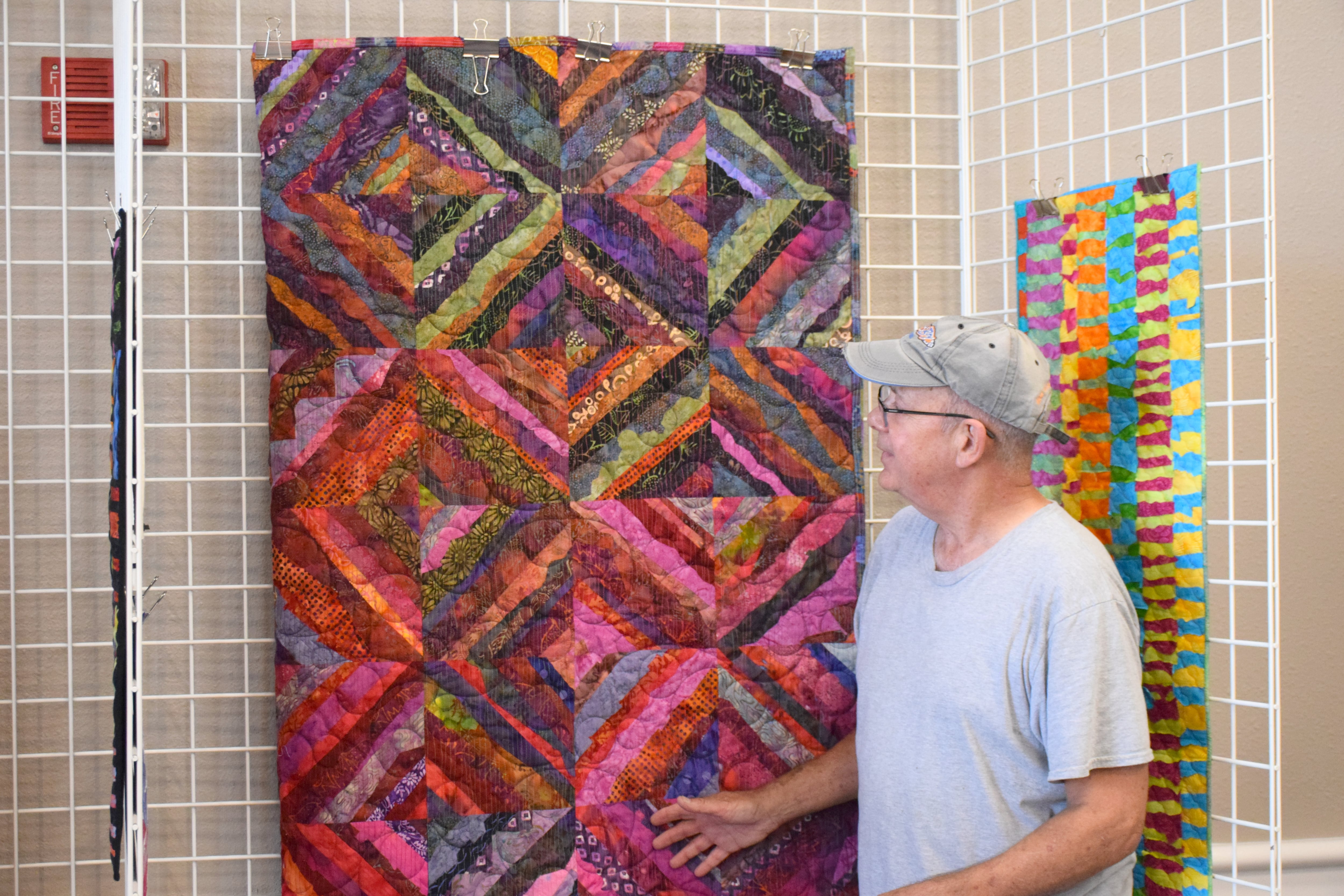 Art display features  variety of colorful quilts