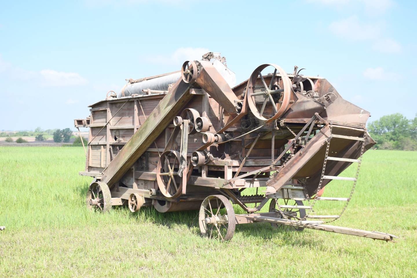 A wooden, horse-drawn threshing machine at the Paul F. Johnson equipment sale.